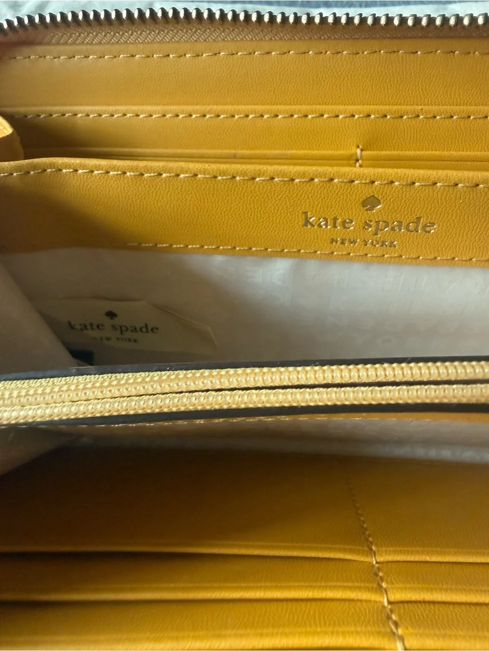 kate spade New York yellow zip-around pebbled leather wallet